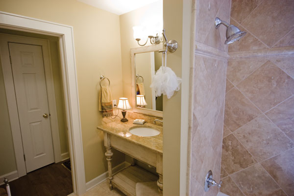 
AFTER. The once-cramped bathroom was opened up by removing a tight closet and features a hardwood cabinet and low-flow fixtures.

